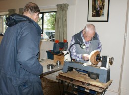 Dave taking an interest in John's bowl turning